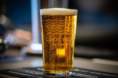 a glass of beer sitting on a table at Aye Stay in Inverness