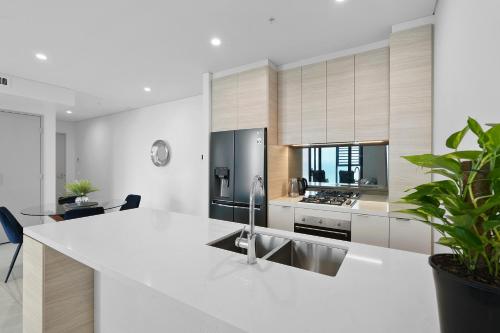 a kitchen with a white counter top and a sink at 43 Stories High Large Villa with Stunning Ocean Views Pet Friendly in Gold Coast