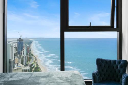 a view of the ocean from a window with a chair at 43 Stories High Large Villa with Stunning Ocean Views Pet Friendly in Gold Coast