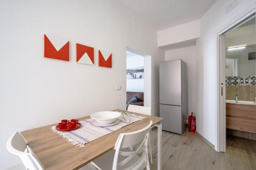 a kitchen and dining room with a wooden table and chairs at Gabbiano 2 - Sea Loft in Bari