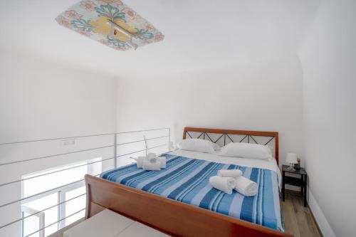 a bedroom with a bed with towels on it at Gabbiano 2 - Sea Loft in Bari