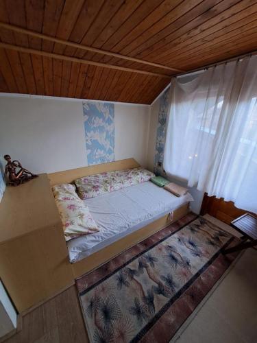a small bed in a room with a window at Vila Dedo Liben in Vratsa