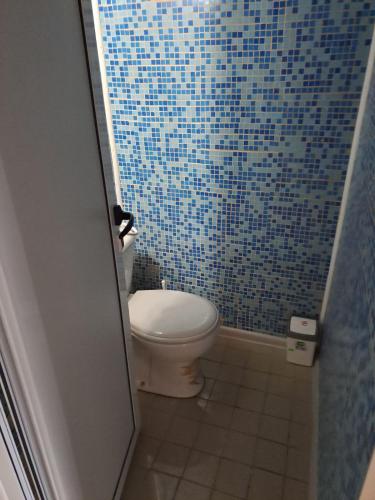 a blue tiled bathroom with a toilet in a shower at Vila Dedo Liben in Vratsa