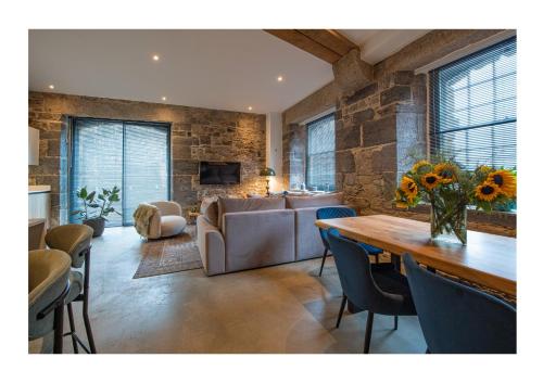 a living room with a couch and a table at No. 15 Factory Cooperage in Plymouth