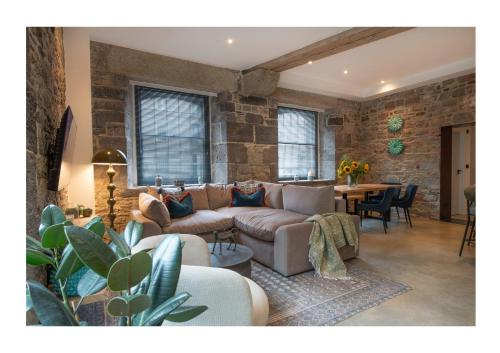 a living room with a couch and a table at No. 15 Factory Cooperage in Plymouth