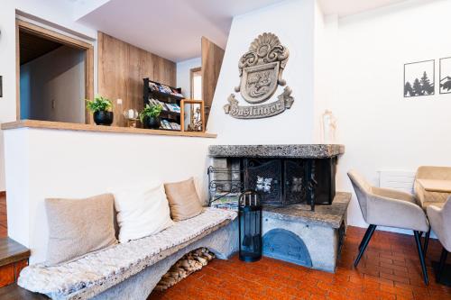 a living room with a couch and a fireplace at Alpenpension Haslinger in Bad Gastein