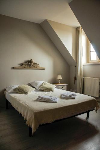 a bedroom with a large bed with an attic at Auberge de la fontaine aux loups in Saint-Sulpice-le-Dunois