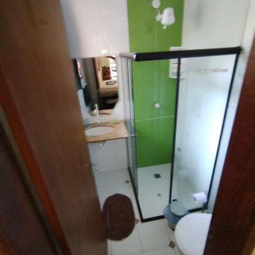 a bathroom with a toilet and a glass shower at L&M Housing Apartamentos y casa in Búzios