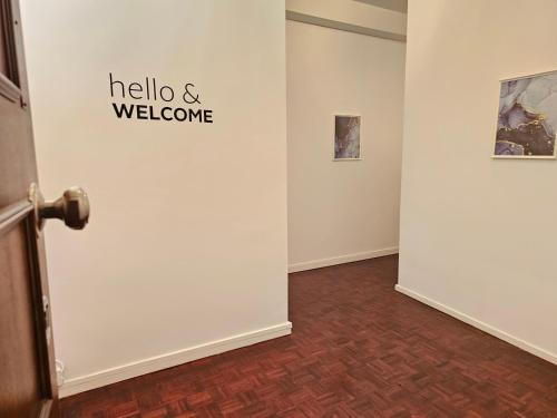 a hallway with a wall with a welcome sign on it at Blife Portugalya - private rooms at Santantonya 2nd floor in Faro