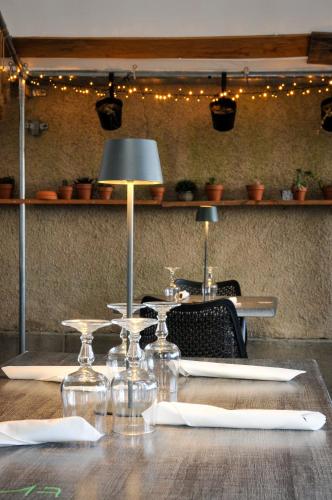 a table with chairs and a lamp on top of it at Auberge de la fontaine aux loups in Saint-Sulpice-le-Dunois