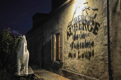 a building with graffiti on the side of it at Auberge de la fontaine aux loups in Saint-Sulpice-le-Dunois