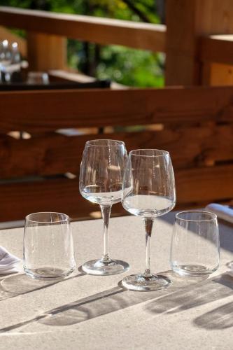 four empty wine glasses sitting on a table at Hob La Truffière in Gignac