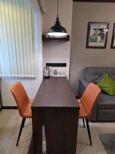 a kitchen and living room with a table and chairs at ARMO Nimman in Chiang Mai