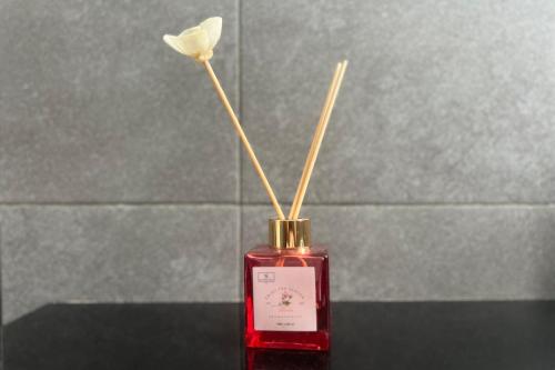 a red bottle with a white flower in it at Civico 44 in Ravenna
