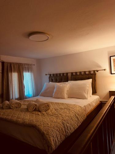 a bedroom with a bed with two towels on it at Porta Mesta in Chios