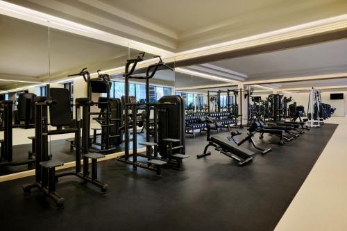 a gym with lots of treadmills and machines at JW Marriott Hotel Bangkok in Bangkok