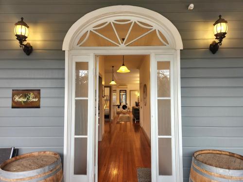 an arched doorway into a dining room with barrels at Westend House Healesville in Healesville