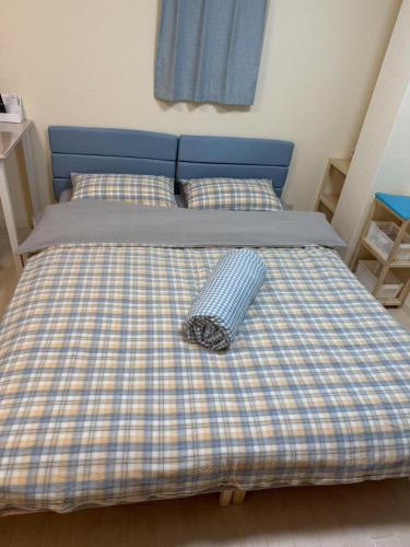 a bed with a checkered blanket on it at ToyamaHouse2-203 in Tokyo