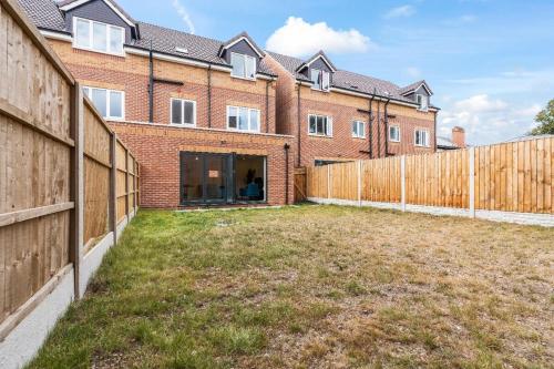 an empty yard in front of a brick building at Modern 4-Bed, Parking, Pool Table, Sleeps 11 in Bescot