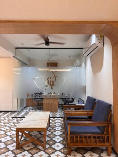 a living room with two chairs and a table at Hotel Royal Galleria in Vadodara