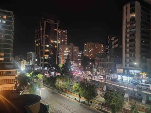 a city lit up at night with buildings at Modern, downtown and sunny! in La Paz