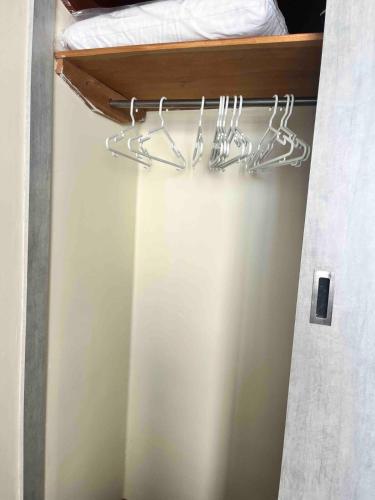 a room with a bed and hangers in a room at Modern, downtown and sunny! in La Paz