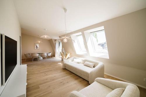 a living room with a couch and a tv at Lindgold in Munich