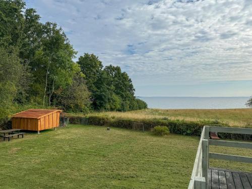 a backyard with a wooden fence and a wooden bench at Holiday Home With Fjord Views By Isefjord in Nykøbing Sjælland