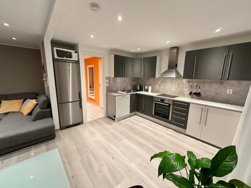 a kitchen and living room with a couch and a kitchen at Cozy house with a sea view in Knarrvika