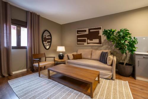 a living room with a couch and a table at VALERIA DREAMS-Mártires 3ºA - EL TUBO in Zaragoza