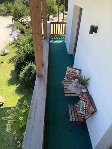a balcony with a table and chairs on a green carpet at Landgasthof Sagenhaft in Klagenfurt