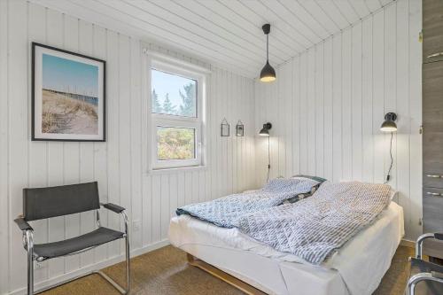 a bedroom with a bed and a chair in it at LN901-Hjorring-Vadehavsvej-27 in Hjørring