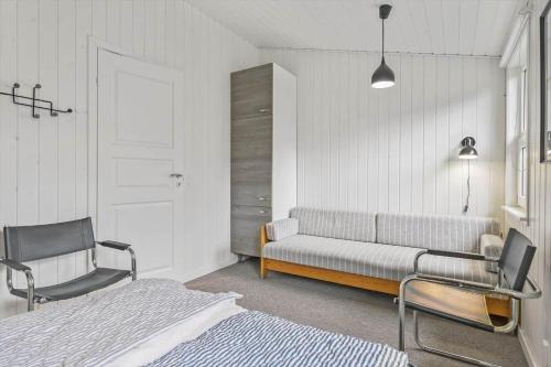 a bedroom with a bed and a couch and a chair at LN901-Hjorring-Vadehavsvej-27 in Hjørring