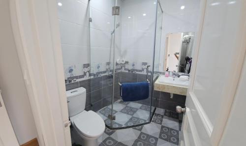 a bathroom with a shower and a toilet and a sink at ADRI Hotel in Phu Quoc