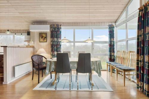 a kitchen and dining room with a table and chairs at LN1971-Lonstrup-Kirkedalsvej-7 in Lønstrup