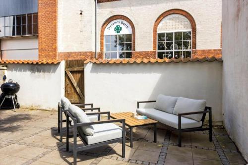 a patio with a couch and chairs and a table at LL249-Rudkobing-Norrebro-49 in Rudkøbing