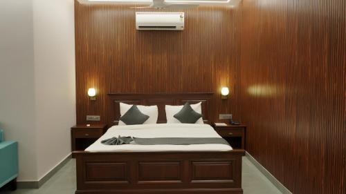 a bedroom with a bed with wood paneled walls at Hotel Devaan in Kālānwāli