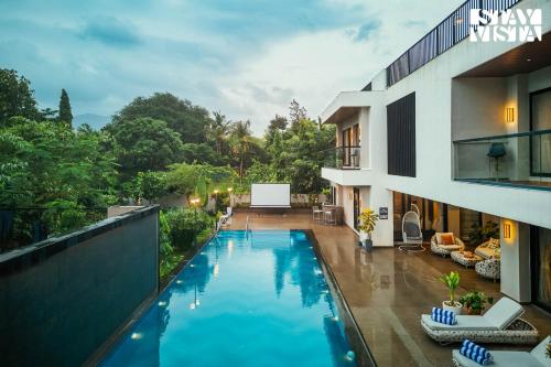 a swimming pool in the middle of a building at StayVista at The Amaryllis with Heated Pool & Projector Set-Up in Karjat