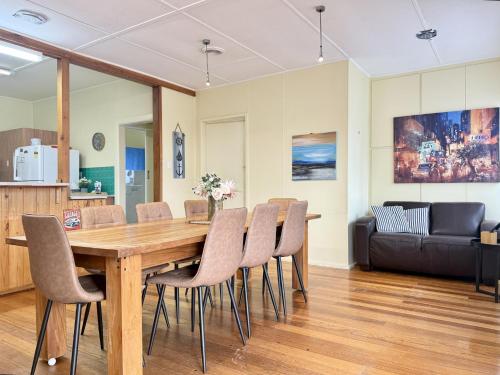 a dining room with a wooden table and chairs at Nautique Beach House - Rustic and Charming, Walk 2 Beach & Shops in Rosebud