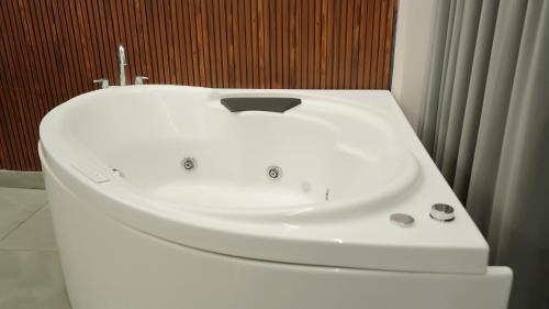 a white sink sitting on top of a toilet in a bathroom at Hotel Devaan in Kālānwāli