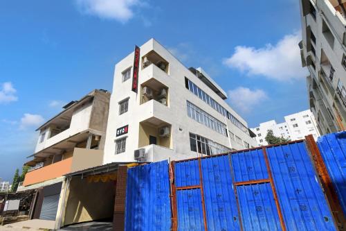 a white building with a blue fence in front of it at Hotel O SK IN in Rānchī