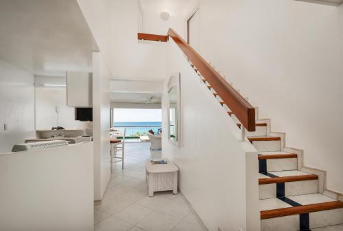 a staircase leading to a kitchen and a living room at Sea View Apartment in Lowlands with Private Pool, 245 sqm in Lowlands