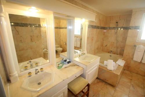 a bathroom with two sinks and a shower and a tub at Sea View Apartment in Lowlands with Private Pool, 245 sqm in Lowlands
