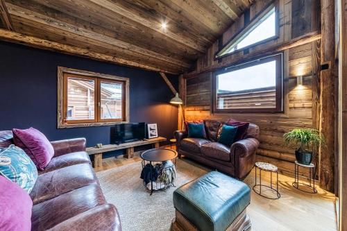 a living room with a couch and a tv at Chalet Saint De l'Elephant in Saint-Jean-dʼAulps