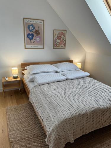 a bedroom with a bed with a white comforter at Stodoła Bieszczady in Nowy Zagórz