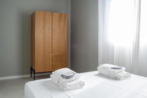 Postel nebo postele na pokoji v ubytování Welc-ōM Green Building Business Padova