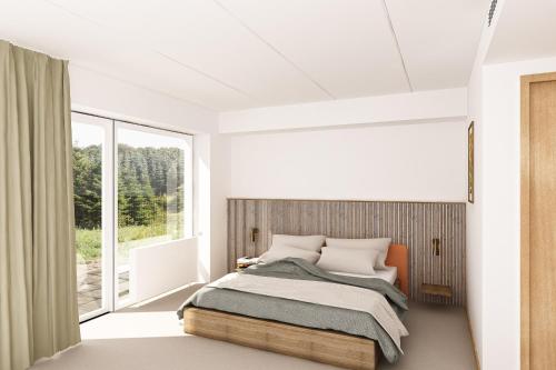 a bedroom with a bed and a large window at Fjelsted Skov Hotel & Konference in Ejby