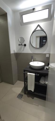 a bathroom with a sink and a mirror at Apartamentos Turisticos Paraiso in Funchal