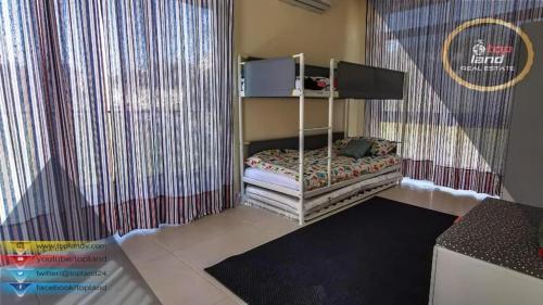 a small bed in a room with a curtain at Villa27 in Amman