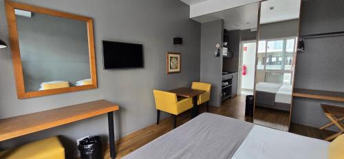 a small room with a table and a mirror at Apartamentos Turisticos Paraiso in Funchal